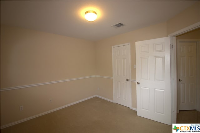 unfurnished bedroom with a closet and carpet