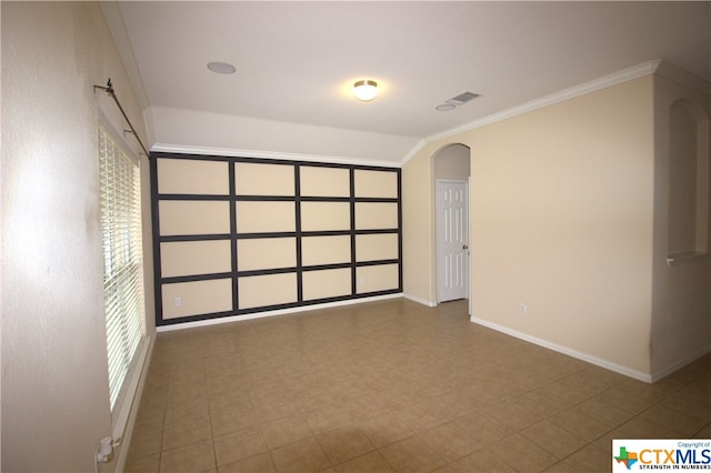 2005 Granite Springs Rd, Leander, TX 78641 - spare room featuring arched walkways, baseboards, and ornamental molding