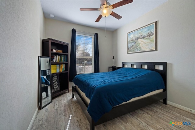2023 Chilton Hall, San Antonio, TX 78253 - bedroom with wood finished floors, a ceiling fan, baseboards, and a textured wall