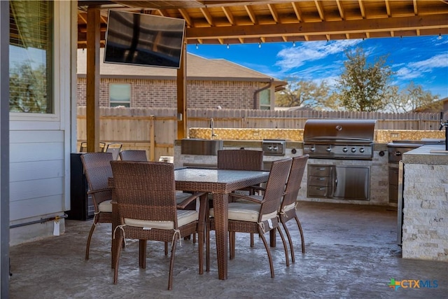 2023 Chilton Hall, San Antonio, TX 78253 - view of patio with outdoor dining area, a grill, fence, and exterior kitchen