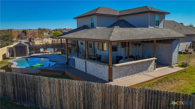 2023 Chilton Hall, San Antonio, TX 78253 - back of property with a fenced in pool, a fenced backyard, a storage shed, an outdoor structure, and a patio