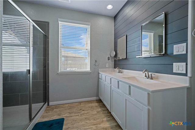 2023 Chilton Hall, San Antonio, TX 78253 - bathroom with a shower stall, wood finished floors, a sink, and double vanity