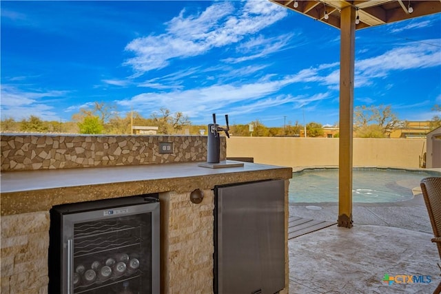 2023 Chilton Hall, San Antonio, TX 78253 - view of patio / terrace with beverage cooler, fence, and a fenced in pool