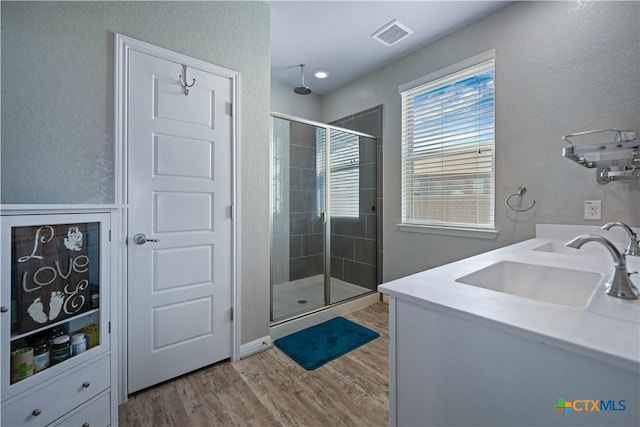 2023 Chilton Hall, San Antonio, TX 78253 - full bathroom featuring a shower stall, wood finished floors, a sink, and visible vents
