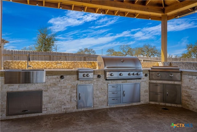 2023 Chilton Hall, San Antonio, TX 78253 - view of patio with grilling area, an outdoor kitchen, a sink, and fence