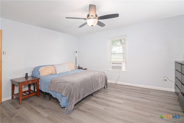 bedroom with ceiling fan and light wood-type flooring