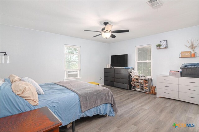 160 Tanglewood Dr, Seguin, TX 78155 - bedroom featuring light wood-style floors, cooling unit, and a ceiling fan