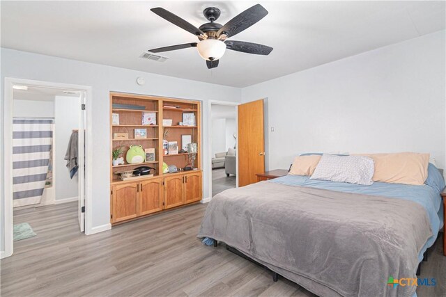 160 Tanglewood Dr, Seguin, TX 78155 - bedroom with light wood finished floors, baseboards, and a ceiling fan