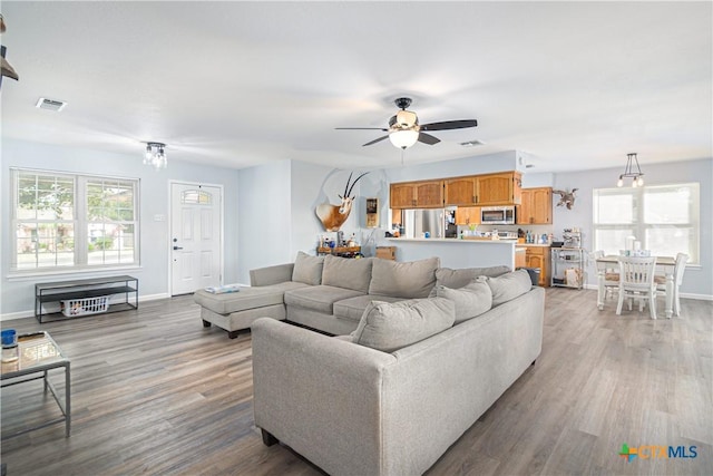 160 Tanglewood Dr, Seguin, TX 78155 - living area featuring wood finished floors, ceiling fan, and baseboards