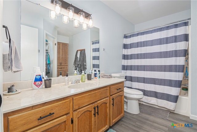 full bathroom featuring wood-type flooring, vanity, toilet, and shower / tub combo