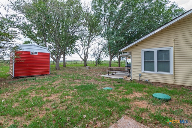 view of yard with a shed and a patio