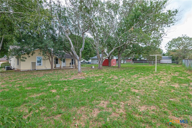 view of yard with cooling unit and a storage unit