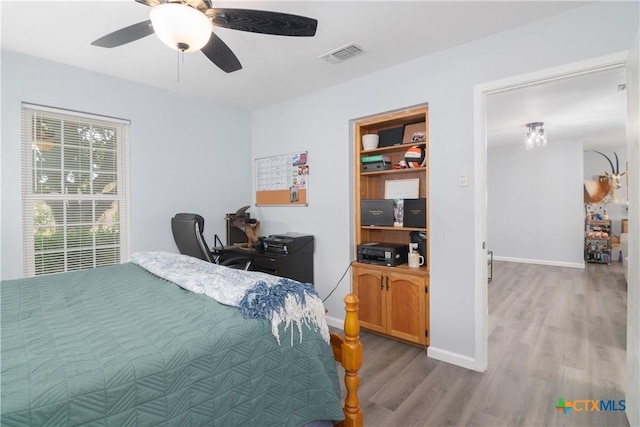 160 Tanglewood Dr, Seguin, TX 78155 - bedroom featuring wood finished floors, baseboards, a desk, and ceiling fan