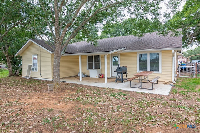 back of property featuring cooling unit and a patio area