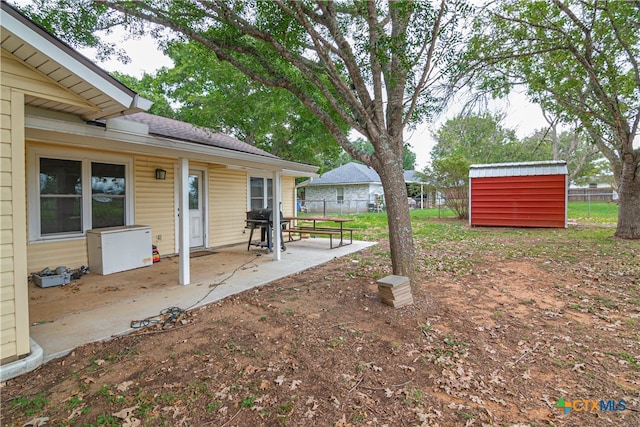 view of yard with a shed and a patio