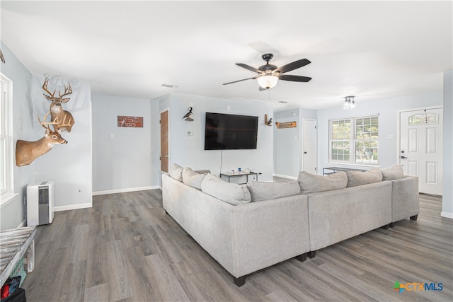 living room featuring wood-type flooring and ceiling fan