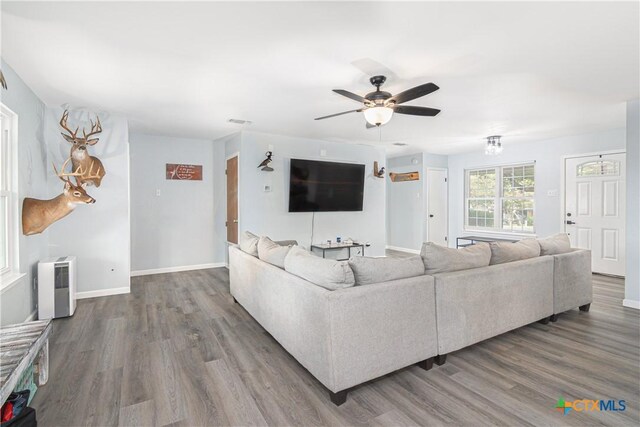 160 Tanglewood Dr, Seguin, TX 78155 - living area featuring wood finished floors, ceiling fan, and baseboards