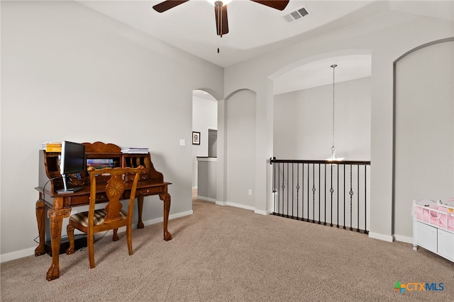 office space featuring carpet floors, ceiling fan, and lofted ceiling