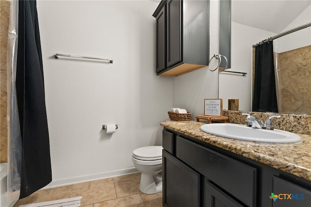 bathroom featuring vanity, tile patterned floors, and toilet