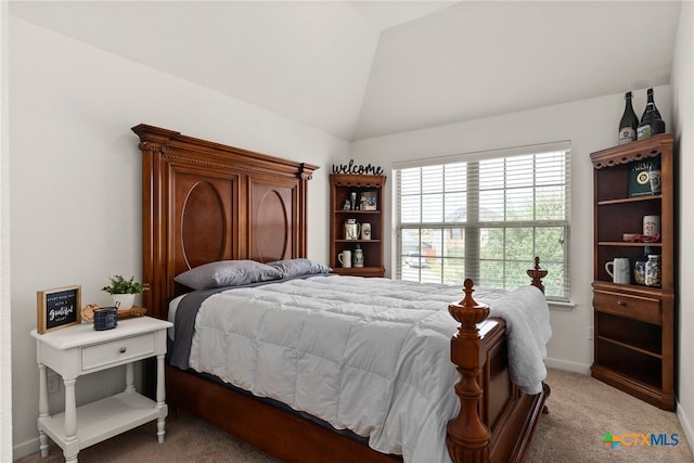 carpeted bedroom with vaulted ceiling