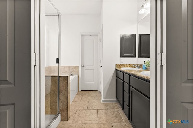 bathroom featuring vanity and independent shower and bath