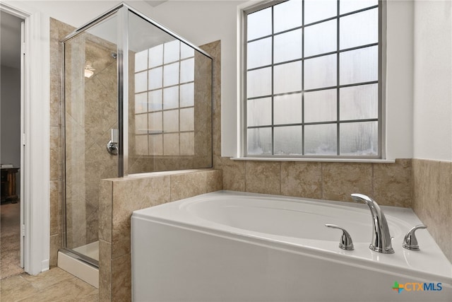 bathroom with independent shower and bath and tile patterned flooring