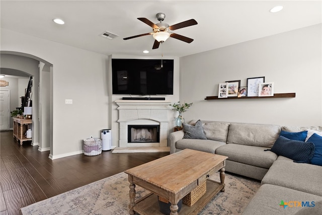 living room featuring hardwood / wood-style flooring and ceiling fan