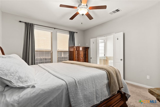 carpeted bedroom with connected bathroom and ceiling fan