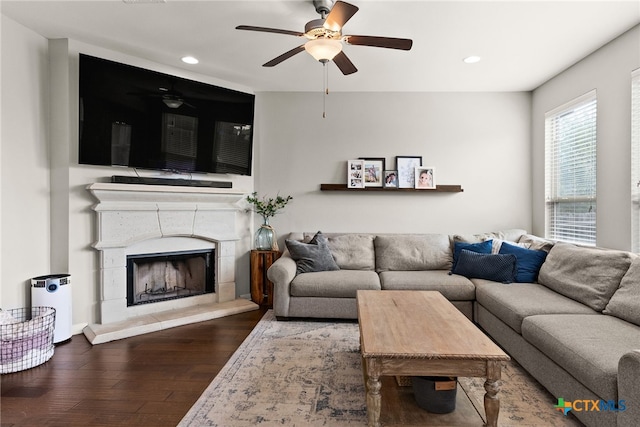 living room with hardwood / wood-style flooring and ceiling fan