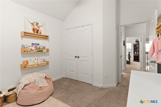 interior space featuring light carpet and lofted ceiling