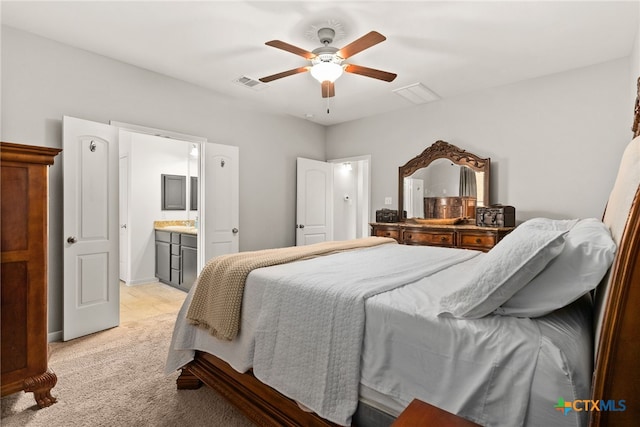 carpeted bedroom featuring ensuite bath and ceiling fan