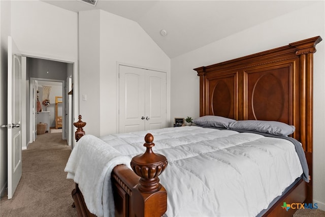 bedroom with lofted ceiling, light carpet, and a closet