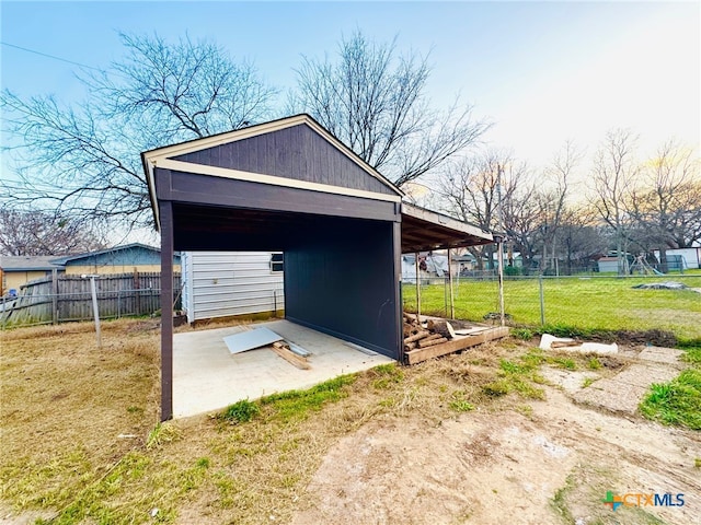 view of outbuilding with fence and an outbuilding