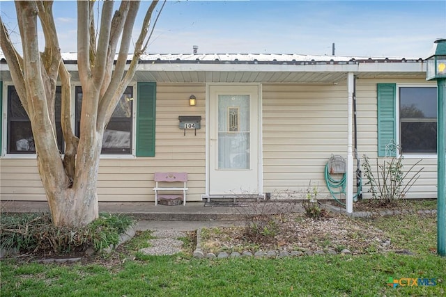 property entrance featuring metal roof