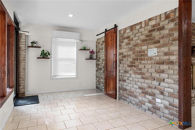 221 W Tanglewood Dr, New Braunfels, TX 78130 - empty room featuring an AC wall unit, a barn door, light tile patterned floors, and brick wall