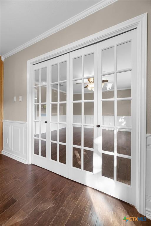 221 W Tanglewood Dr, New Braunfels, TX 78130 - detailed view of crown molding, wood finished floors, wainscoting, a decorative wall, and french doors
