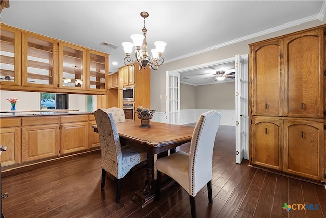 221 W Tanglewood Dr, New Braunfels, TX 78130 - dining room with a chandelier, crown molding, dark wood-style floors, wainscoting, and a ceiling fan