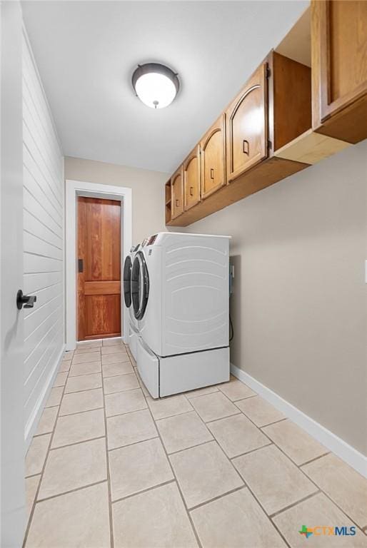 221 W Tanglewood Dr, New Braunfels, TX 78130 - laundry room featuring independent washer and dryer, light tile patterned floors, and cabinet space
