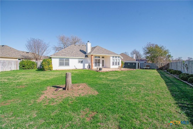 back of property featuring a yard and a patio