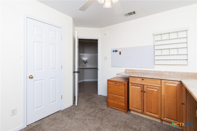 kitchen featuring ceiling fan and light colored carpet