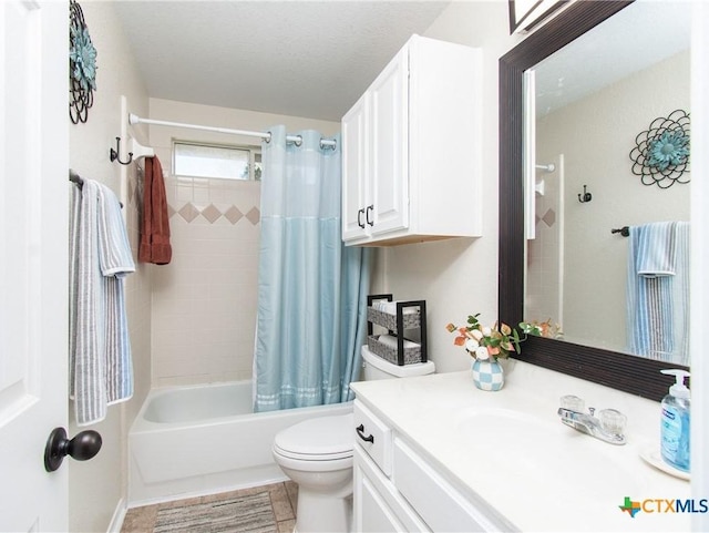 full bathroom with shower / bath combo, tile patterned floors, vanity, a textured ceiling, and toilet