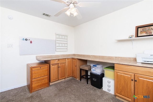 interior space with dark carpet and ceiling fan