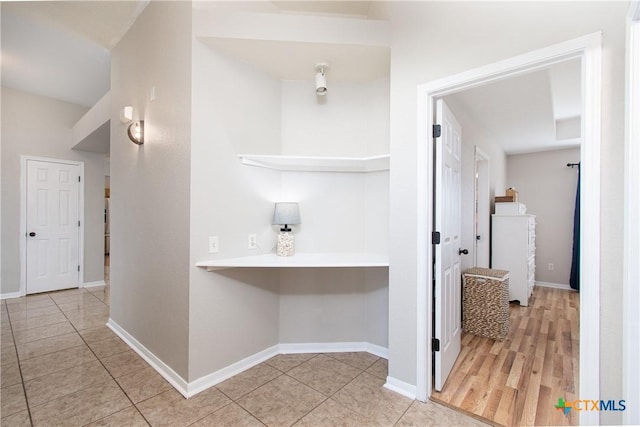 hallway featuring light tile patterned floors