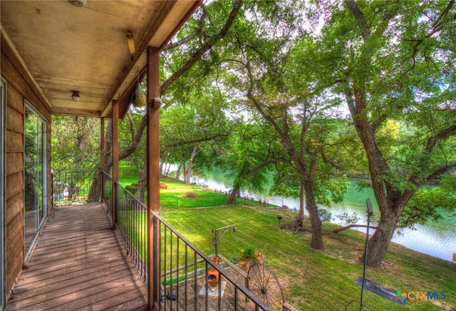 wooden deck featuring a water view and a yard