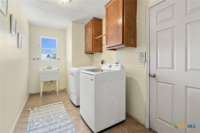 3197 Robin Ln, Kempner, TX 76539 - laundry room featuring washer and dryer, cabinet space, light tile patterned floors, and baseboards