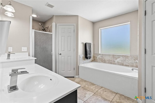 3197 Robin Ln, Kempner, TX 76539 - full bathroom featuring tile patterned floors, a garden tub, double vanity, and a shower stall