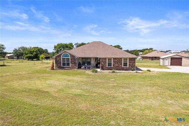 3197 Robin Ln, Kempner, TX 76539 - ranch-style house with an outdoor structure, a front yard, driveway, and brick siding