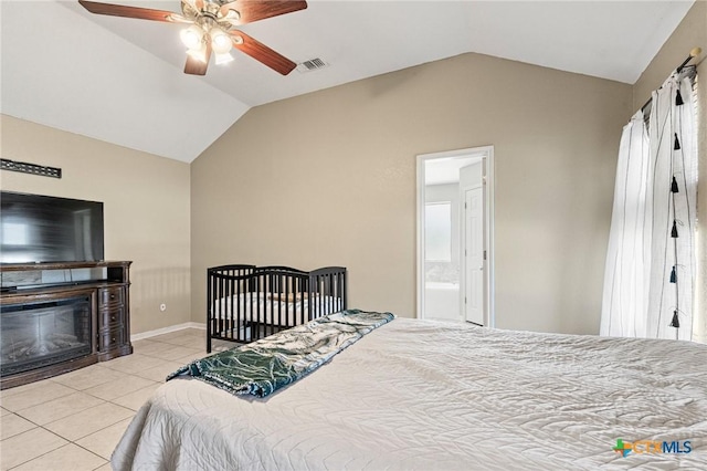 3197 Robin Ln, Kempner, TX 76539 - bedroom featuring vaulted ceiling, light tile patterned floors, a glass covered fireplace, and a ceiling fan
