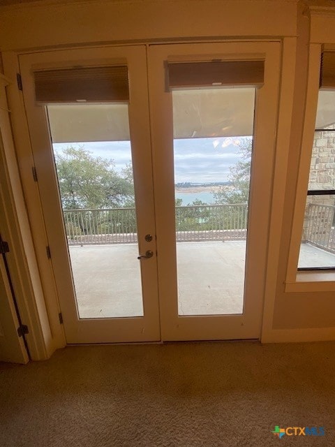 doorway to outside featuring light carpet and french doors