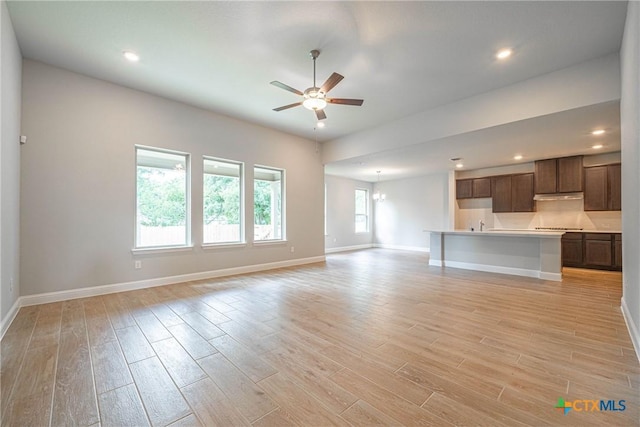 unfurnished living room with ceiling fan